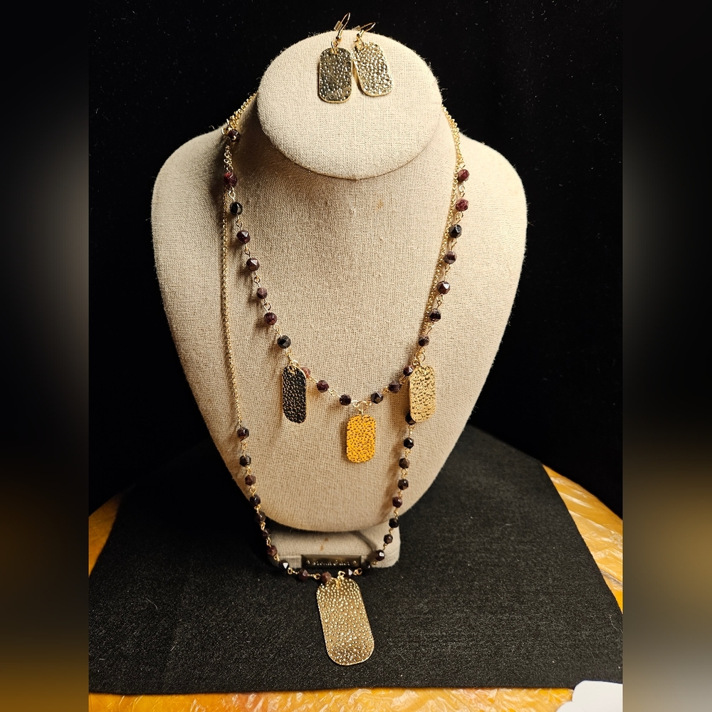 Handmade by me. Beaded garnet stone and hammered gold tone accents.